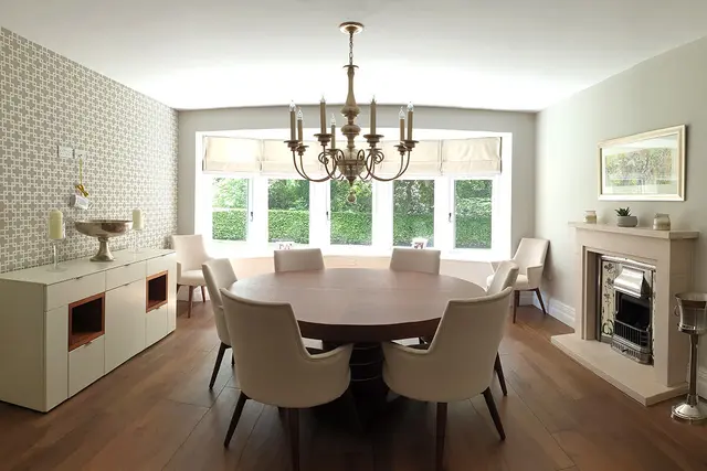 Renovated dining room with chandelier, bay window and feature fireplace